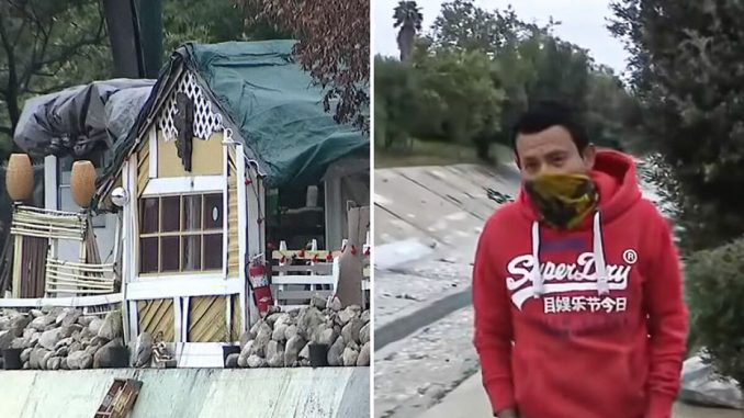 “Give This Man A Job”: Homeless Man Builds Makeshift Home Next To Freeway With Lights, TV, Fridge